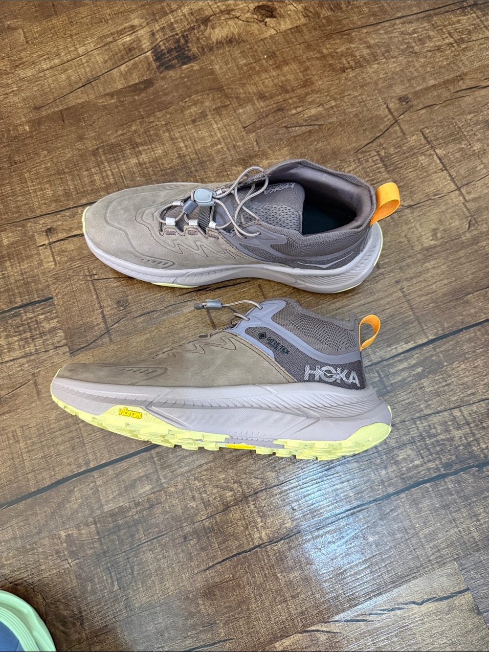 Hoka woman’s Gray Trail Sneakers with Yellow Accents